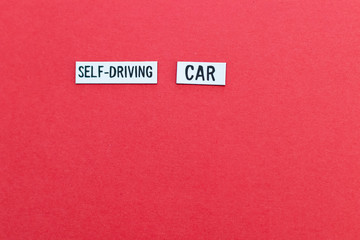Fototapeta na wymiar SELF DRIVING CAR text on label on red background. Autonomous driving background with copy space to write your personalized message. Automotive background with artificial intelligence
