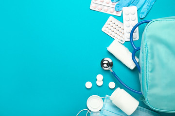 First aid kit on color background