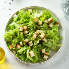 Homemade Caesar salad on a white plate