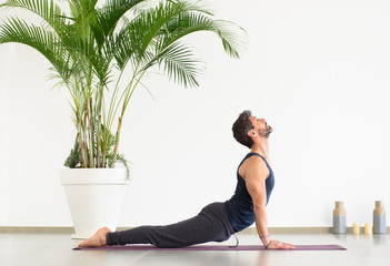 Man doing upward facing dog yoga pose