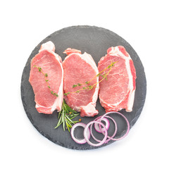 Slate plate with raw pork meat on white background