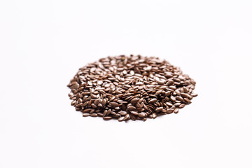 Closeup flax seeds on a white isolated background.