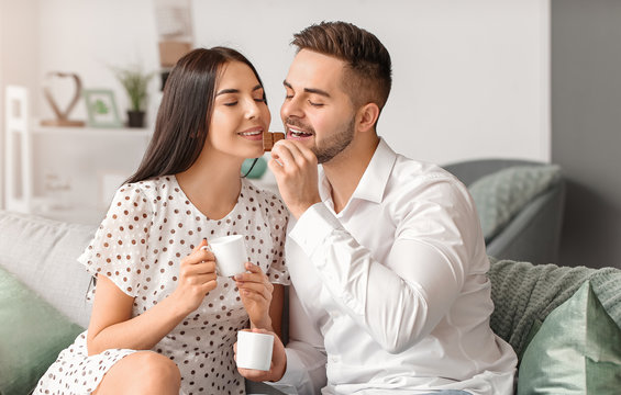 Beautiful Young Couple Eating Chocolate At Home