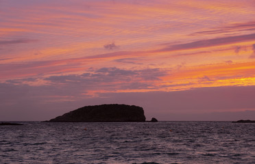 Sunrise with red sky on the beach of Es Canar, Ibiza Island, Spain