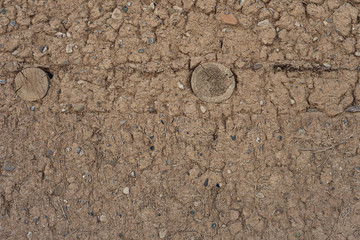 brown grunge background. texture. old clay wall with straw and wooden pillars. grunge cracked background on clay wall. Middle Asia. Kazakhstan. aul. high quality background. natural 