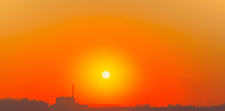 Heatwave hot sun. Global warming llimate change. Summer background with a magnificent summer sun. Autumn sunset. The setting sun in a clear sky. Hot city weather concept. High temperature at summer.