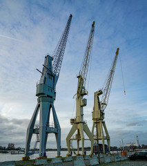 Fototapeta na wymiar old cranes in the harbour of antwerpen belgium