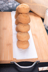 Butter cookies pile on a wooden board