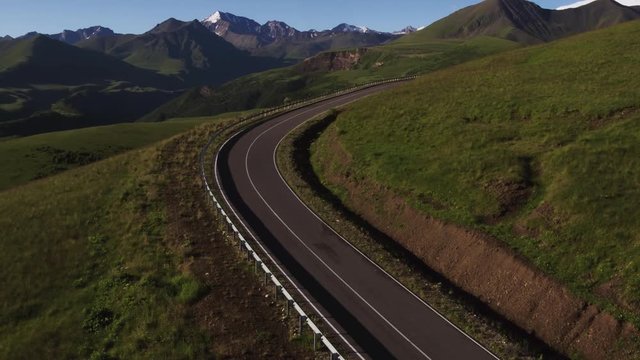 Empty serpentine road, Kislovodsk - Dzhily Su asphalt dangerous beautiful winding freeway to Mount Elbrus in caucasus mountains at summer sunny morning - Aerial drone view