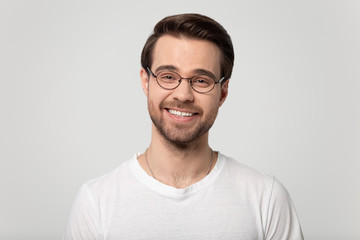 Young happy guy wearing glasses looking at camera portrait.