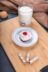 Vanilla meringue cake with a glass of milk