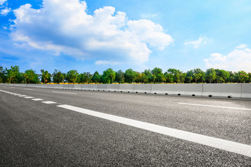 Empty asphalt road and woods background landscape