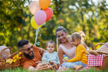 Happy family having picnic in the park