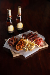 sausage snacks on a wooden background for beer