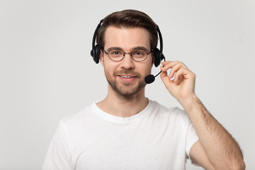 Handsome young man wearing wireless bluetooth headset with microphone.
