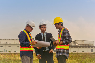 Manager project communication with Foreman Supervisor check on blueprint estate building construction