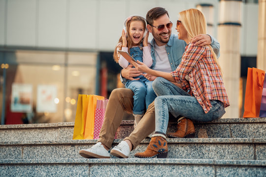 Happy Family With Shopping Bags