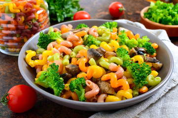 Cavatappi colored pasta with broccoli and mushrooms. Pasta colorata. Pasta with vegetables.