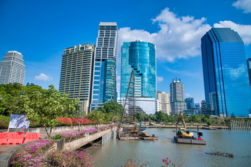 Benjakitti Park in Bangkok, Thailand. Panoramic view of buildings, lake and trees on a sunny day