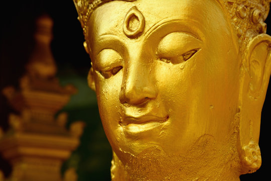 Closeup detail of golden buddha statue