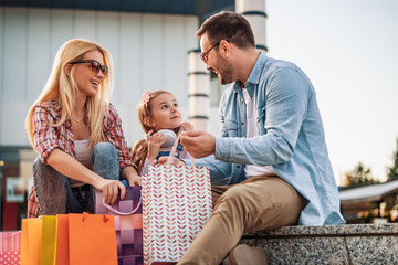 Happy family with shopping bags