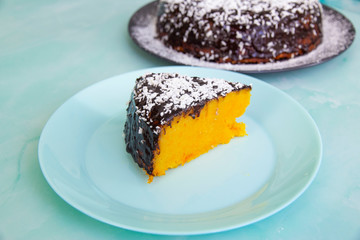 Pumpkin pie with chocolate syrup and coconut shavings