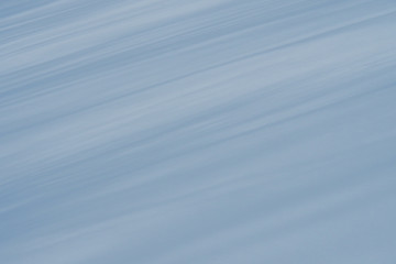 Background of blue stripes at an angle on white snow.