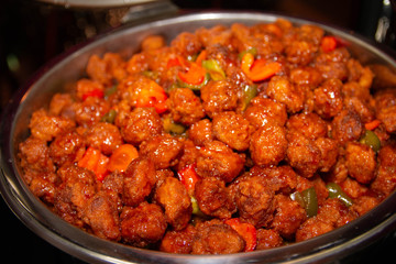 Large bowl of meatball sauce on a buffet tray.