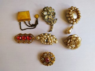 Old vintage brooches. A collection of several pieces close-up on one sheet.