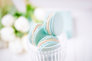 Mint or tiffany color macaron or macaroon dessert with vanilla cream in glass. Copy space - obrazy, fototapety, plakaty