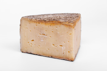 french cow's milk cheese called Tomme de Savoie isolated on white background