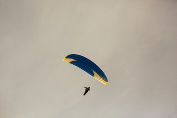 Man flying with paraglider. On lake Albano background, Italy. Paragliding in the Sky. Extreme sport. View of the Lake Albano. Panorama of the gorgeous lake.