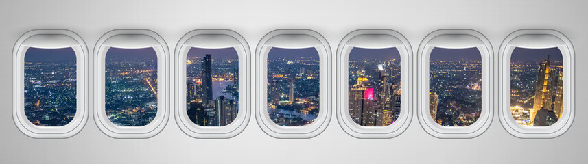 Fototapeta na wymiar Airplane windows with Bangkok night skyline view, Thailand. Travel and holiday abstract concept
