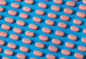 hiv therapy pills on blue background.