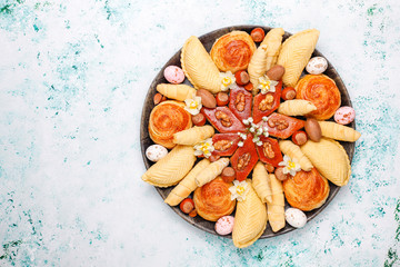 Traditional Azerbaijan holiday Novruz cookies baklavas and shakarburas on black tray plate on light background