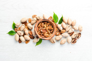 Delicious Pecan nuts on white background Wooden. Top view. Free space for your text.