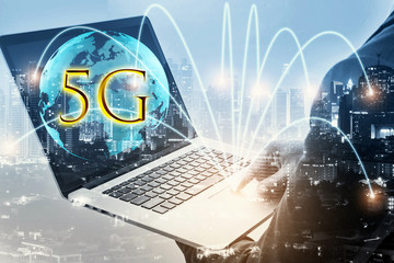 Double exposure of businessman using laptop with growing globe animation model with 5G and connection line. Business for new mobile internet services are already on offer to connection