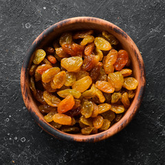 Raisins of white grapes in a bowl. Dried fruits. Top view. Free space for your text.