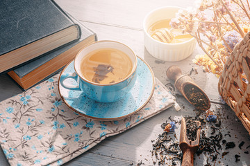 tea in a blue porcelain cup on a table in the sun