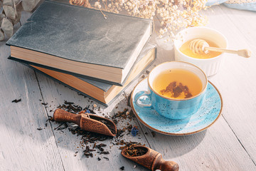 tea in a blue porcelain cup on a table in the sun