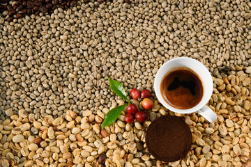 Espresso coffee in a white cup on the background is an Arabica coffee bean.