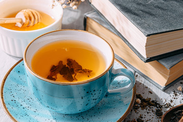 tea and a book in the spring sunshine. near honey and flowers