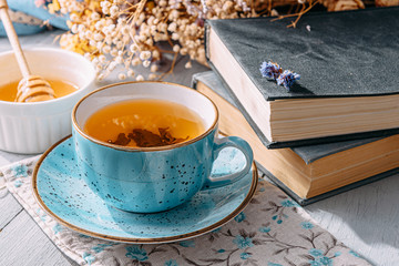a cup of delicious and fragrant spring tea in a blue mug in the morning sun