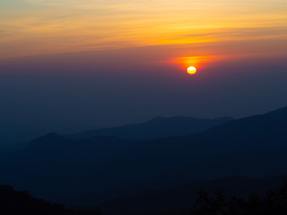 dramatic sunset over cloudy sky.