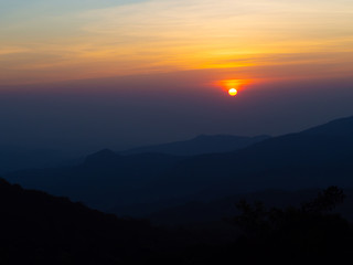 dramatic sunset over cloudy sky.