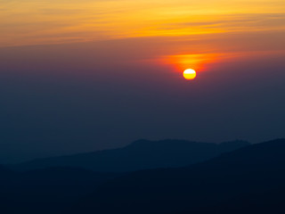 dramatic sunset over cloudy sky.