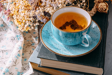 tea and a book in the spring sunshine. near honey and flowers