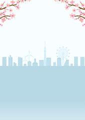 Cherry blossom twigs and silhouette of cityscape, vertical layout