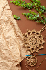 Fototapeta na wymiar Kraft paper, jute washcloth, knitting. Concept zero waste. vertical photo, DYI