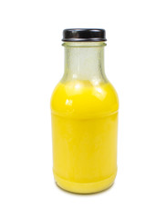 Delicious homemade fresh corn milk in glass bottle with corn seeds on white background.